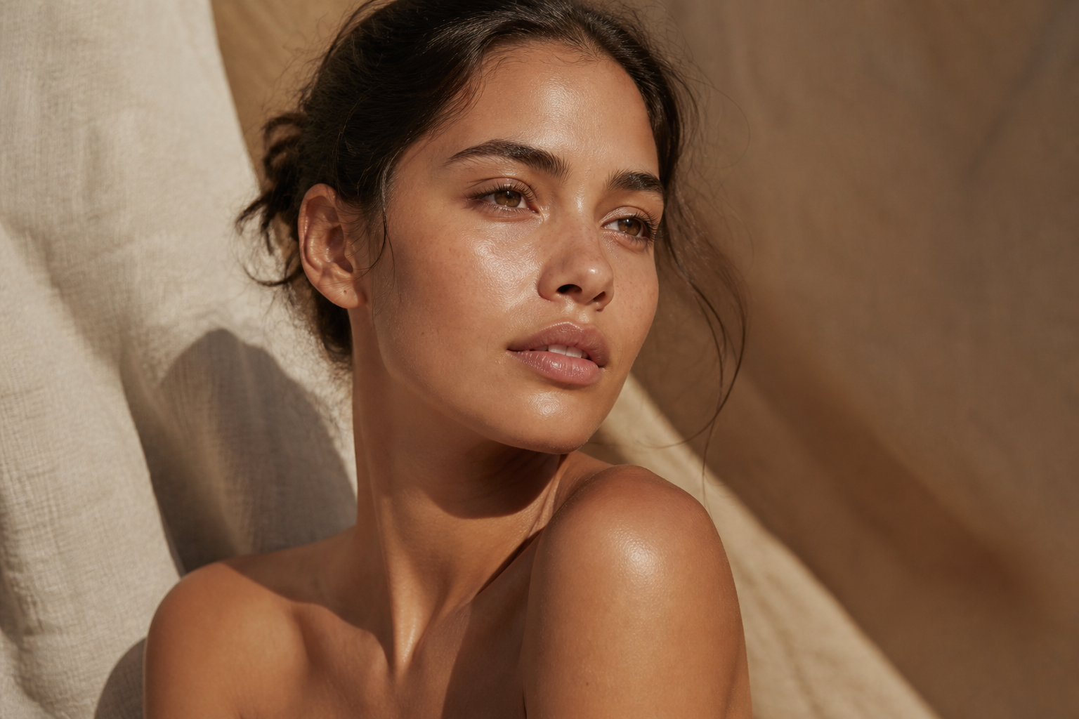 Campaign still: warm bronze glow on linen